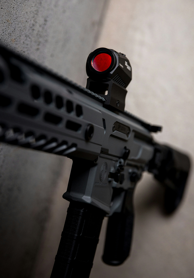 black rifle with red magnifying glass
