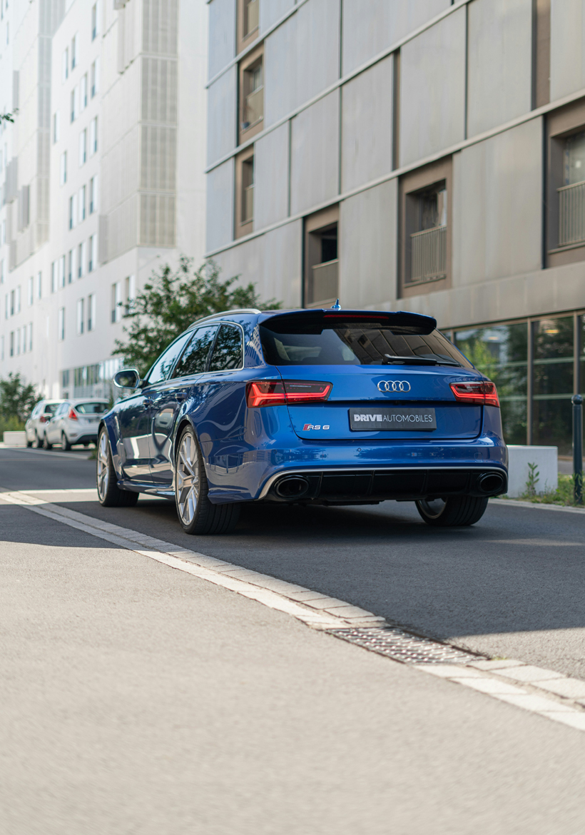 blue color audi car parked at the street area