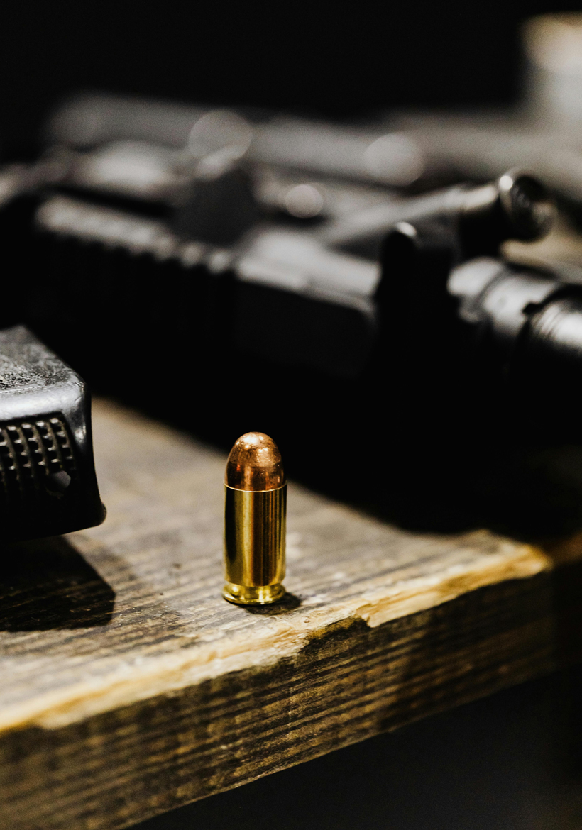 bullet is placed on the wooden surface