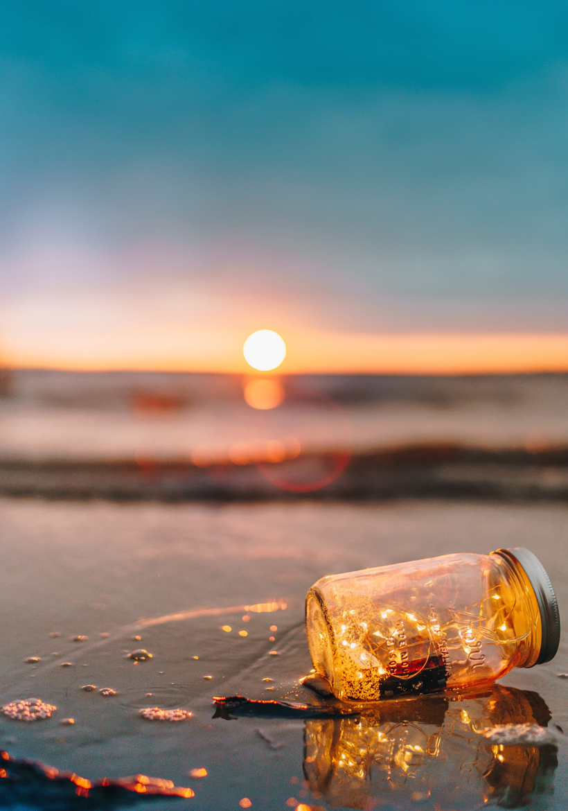 glitter in clear glass jar in sunset light