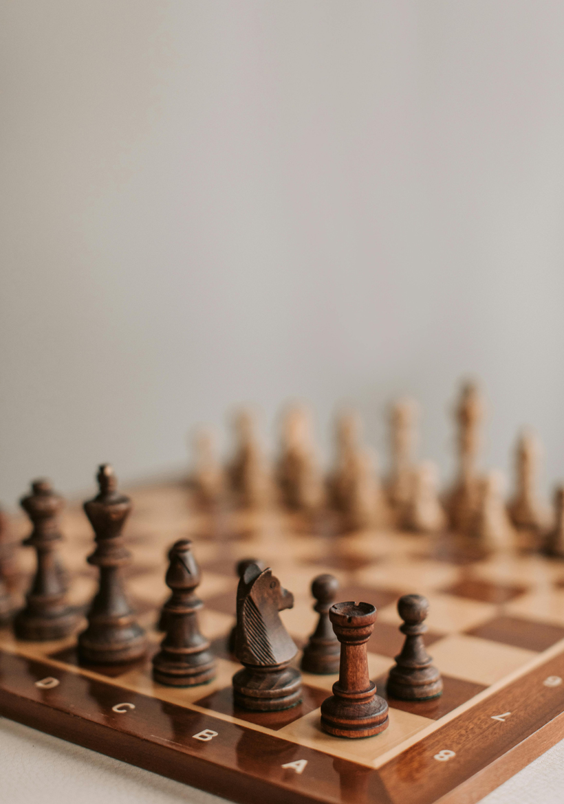 glossy finished wooden chess board with pieces