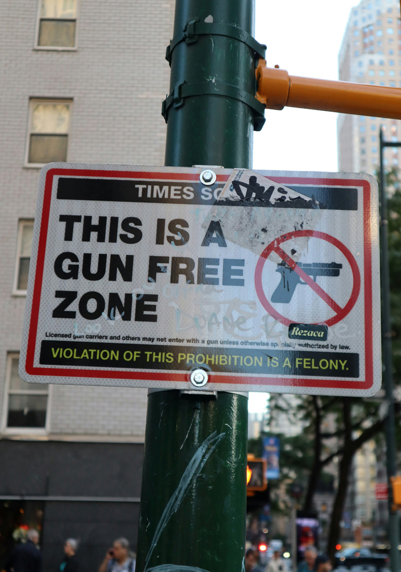 gun free zone board on street