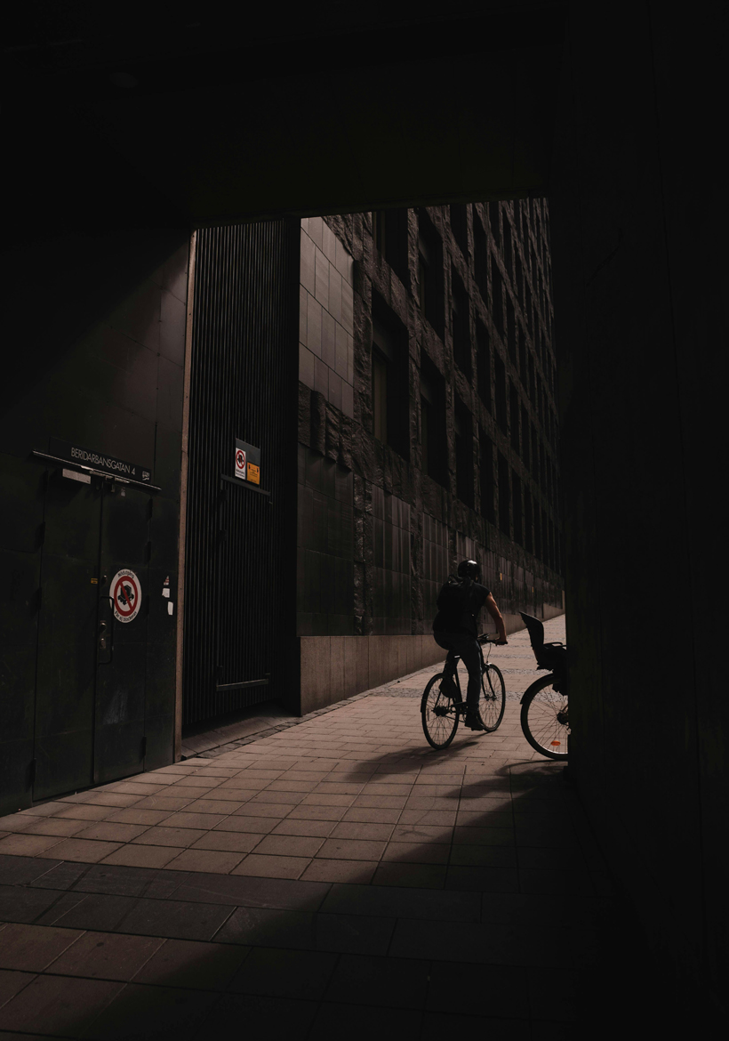 man on cycle near dark street area