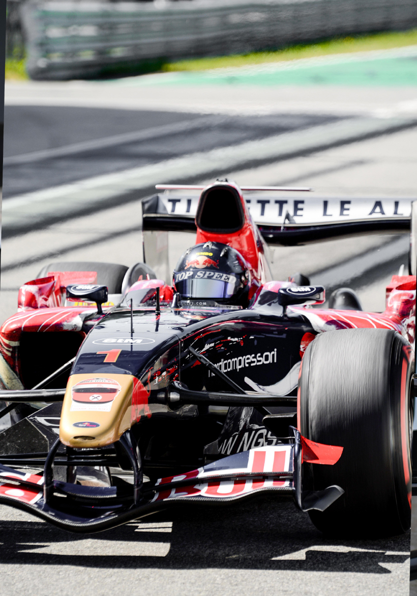 man sitting in red and black racing car