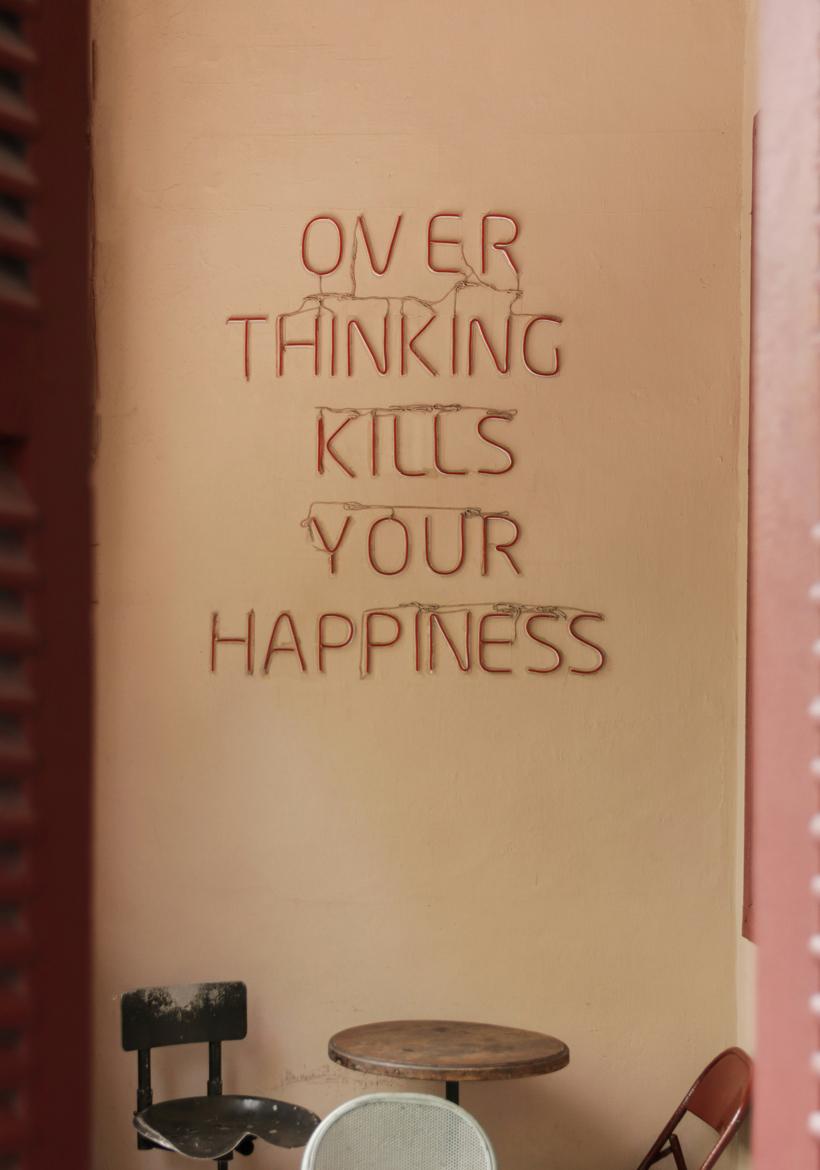 overthinking quotation written on paper board