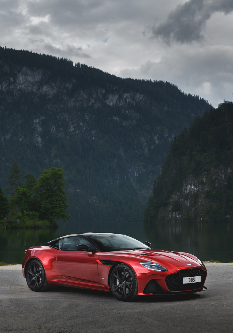 red color supercar parked on hill