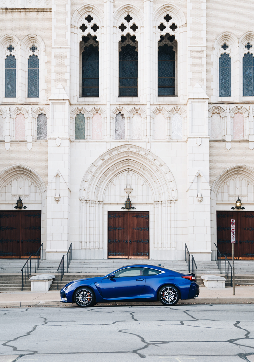 shining dark blue color parked in front of cathedral building