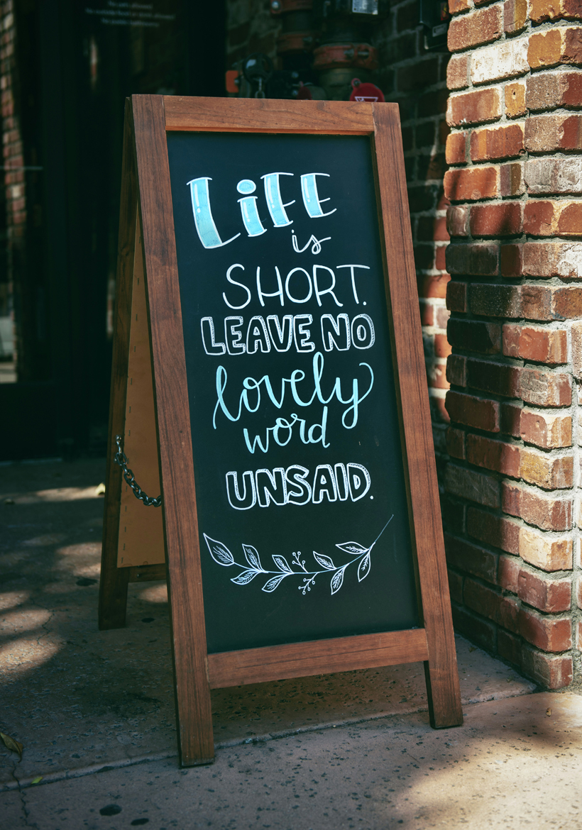 short life quotation on wooden frame