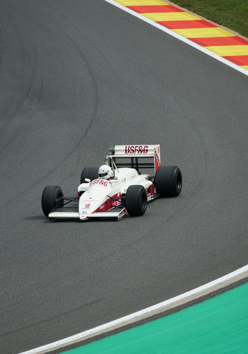 white and red color f1 car race on track