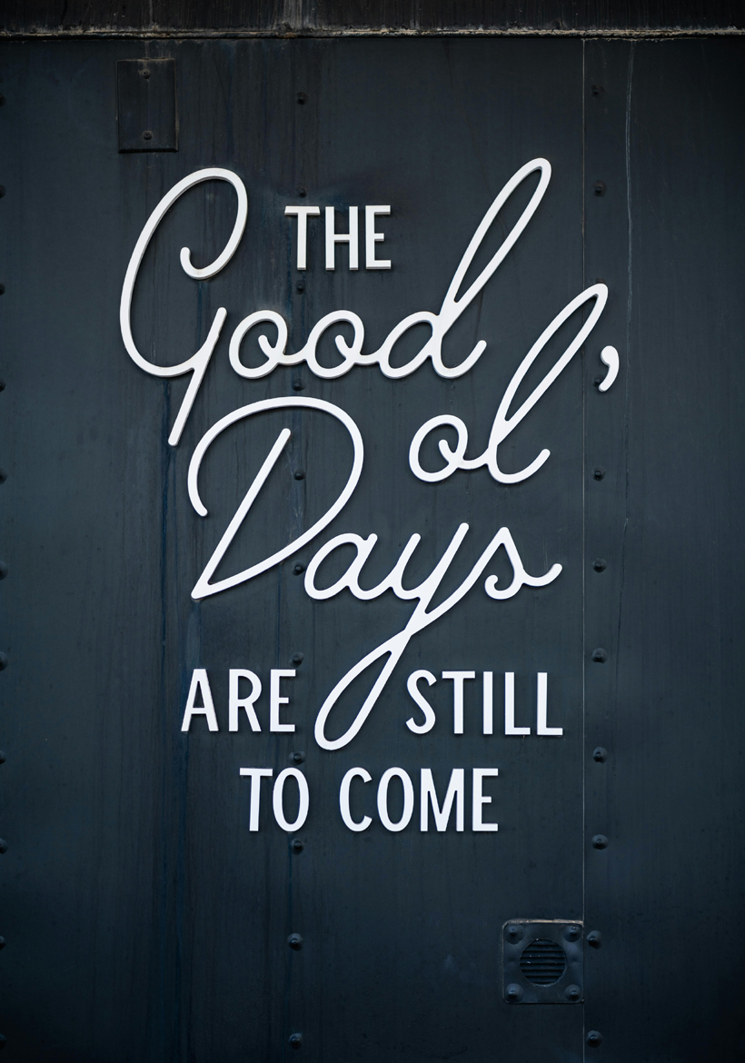 white text quotation front of grey metal background
